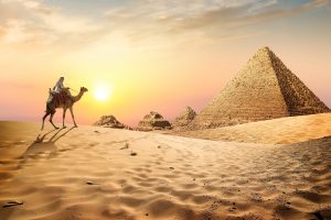 Egyptian pyramids in the desert at sunset